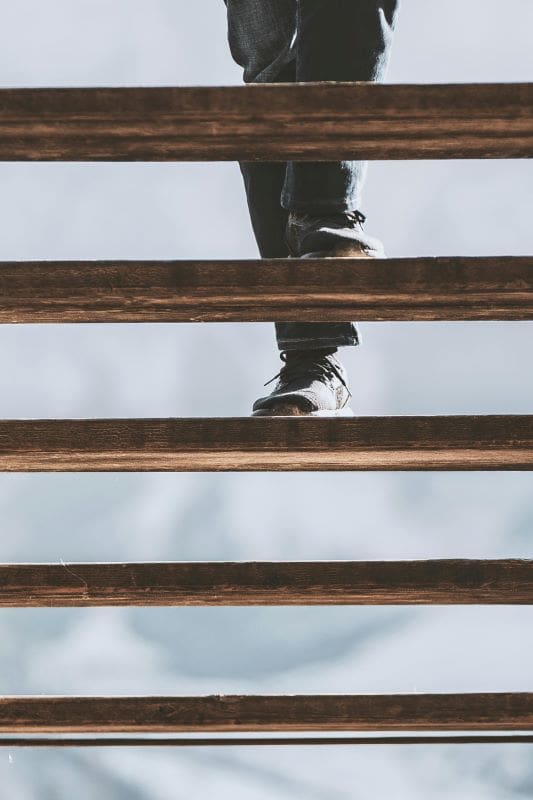 Staircasing Mortgages | Person walking up wooden stairs