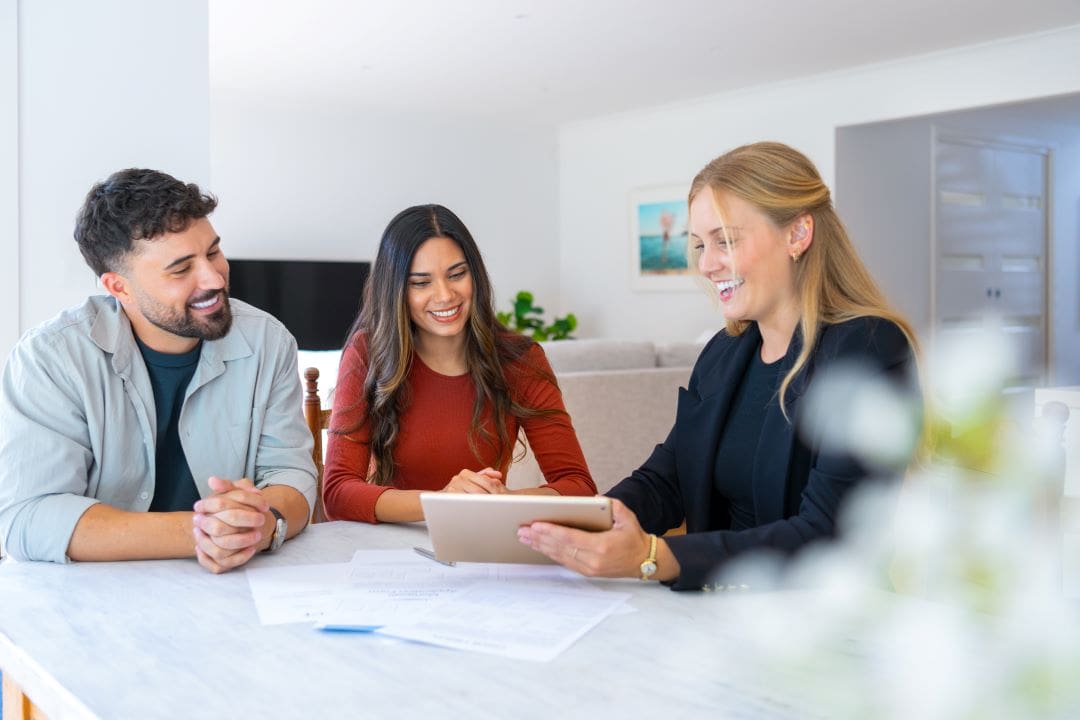 Joint Borrower Sole Proprietor Mortgage Advisor with a couple looking through documents