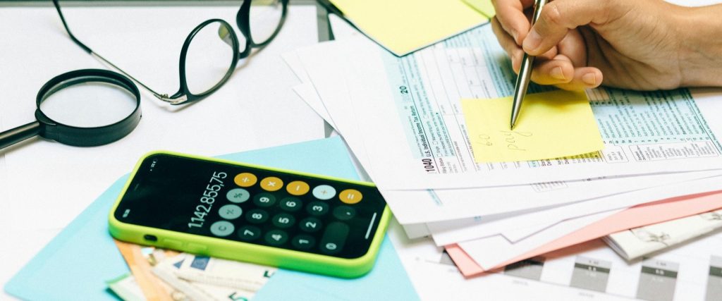 Calculator and paperwork for a gifted deposit mortgage affordability check